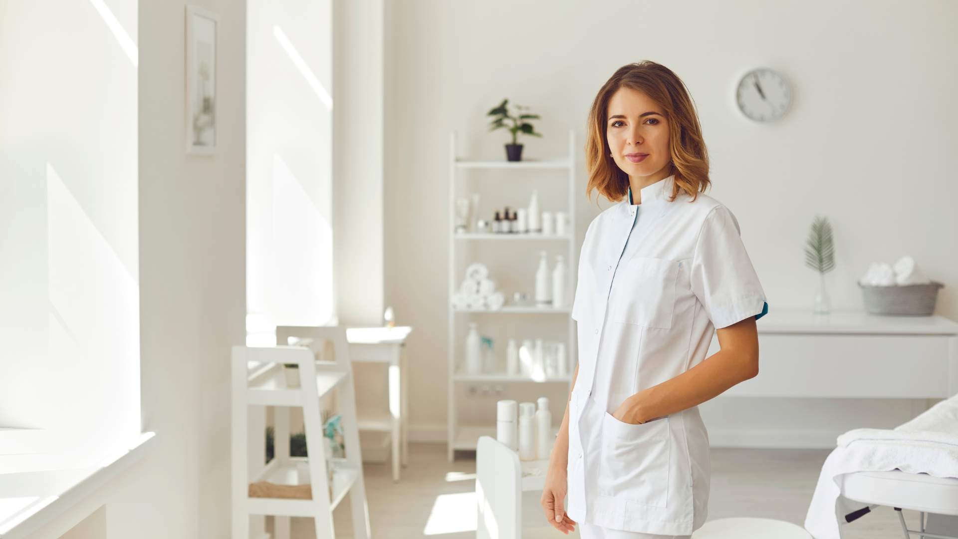 Smiling Woman Cosmetologist or Dermatologist Standing and Looking at Camera in Beauty Spa Salon
