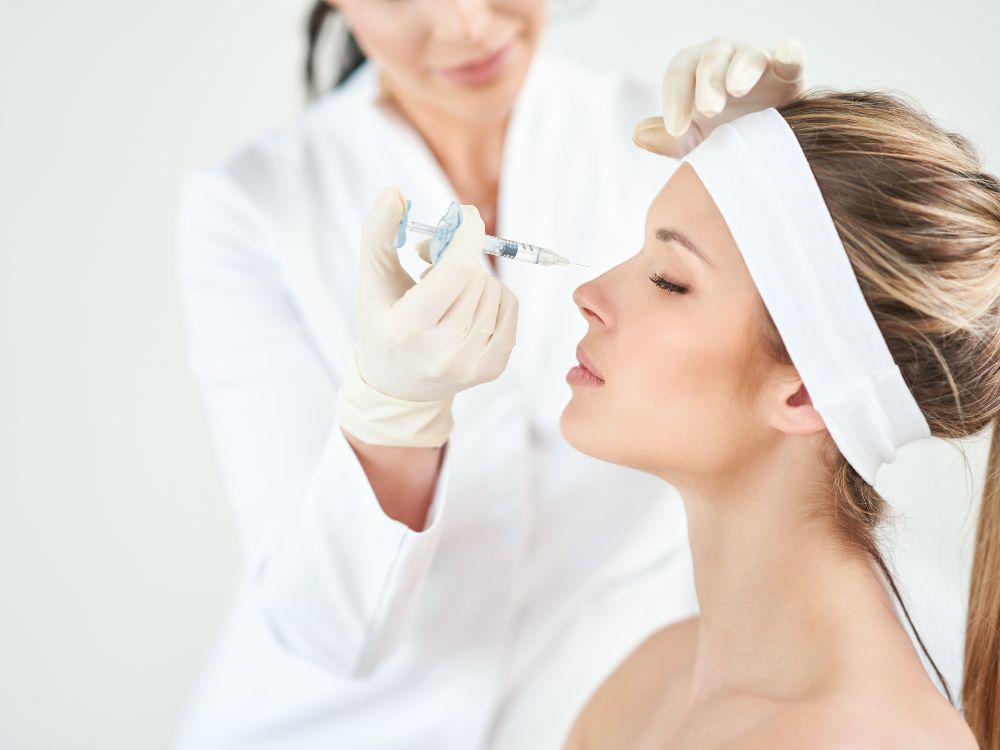 A nurse injecting botox to the cheek