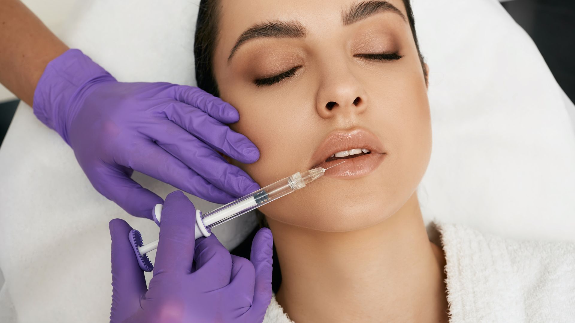 Lips filler injection for beautiful woman lip augmentation with hyaluronic acid at a beauty salon. Lip Filler Techniques