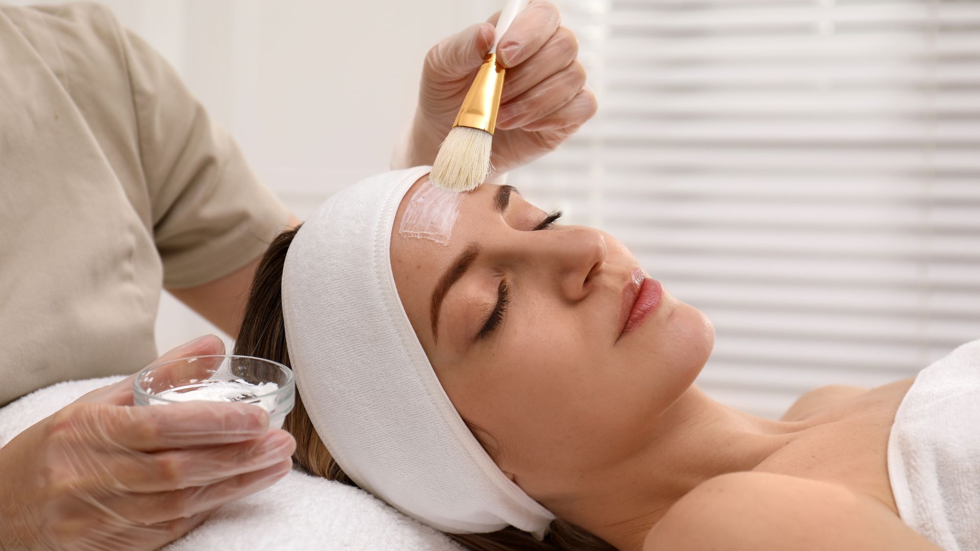 Young Woman during Face Peeling Procedure in Salon
